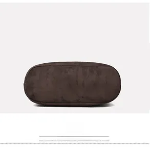 Detailed base view of the dark brown suede crossbody bag with precise stitching