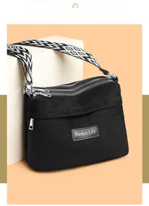 Detail of multi-compartment nylon crossbody bag with geometric pattern wide strap
