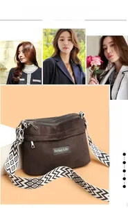 Detail of dark brown crossbody bag with triple zippers and geometric wave shoulder strap