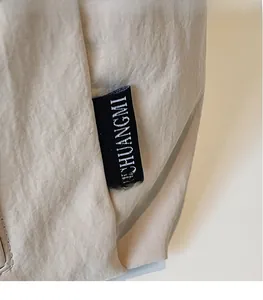 Detailed close-up of water-resistant nylon tote fabric and CHUANGMI brand tag logo