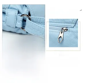 Details einer hellblauen Ledertasche mit glänzenden Metallschnallen und Schultergurten