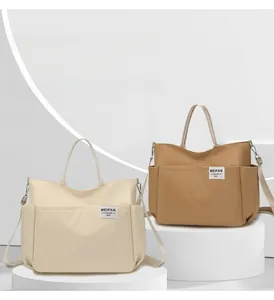 Detailed view of large nylon tote bag with side pockets and adjustable shoulder strap