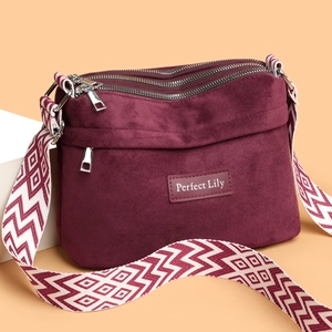 Burgundy nylon pillow bag with three zip layers and geometric woven shoulder strap