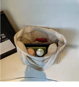 Top view of large capacity cream tote bag showing spacious interior with multiple compartments