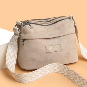 Minimalist beige nylon pillow shoulder bag with multi-layer zippers and woven strap