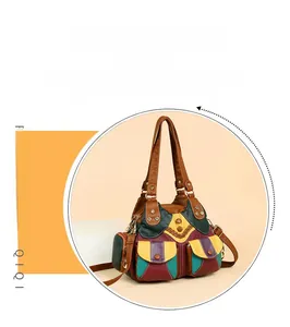 Close-up of retro multi-color patchwork handbag with metal studs and zipper pockets