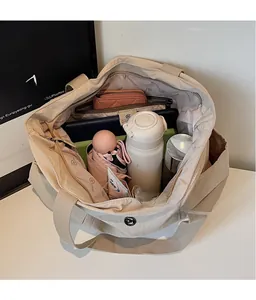 Spacious interior of waterproof nylon tote bag showing compartments for water bottle and wallet