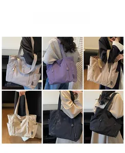 Showcase of minimalist nylon tote bags in six colors including grey, beige, and black
