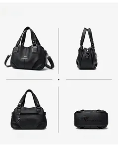 Dettagli della borsa tote in pelle nera con finiture metalliche e tracolla regolabile