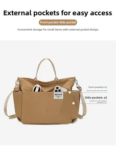 Detail of khaki nylon tote bag showing dual front pockets and spacious side storage