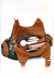 Interior view of the multi-compartment leather handbag showing high storage capacity