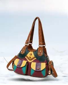 Detail of multi-color patchwork leather handbag with vintage rivets and multi-pocket design