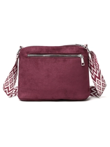 Close-up of wine red matte crossbody bag with bohemian patterned jacquard strap