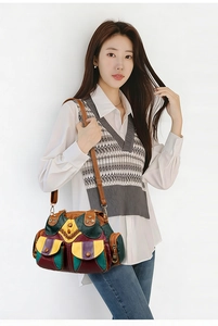 Detailed view of a colorful patchwork leather shoulder bag featuring vintage ethnic patterns