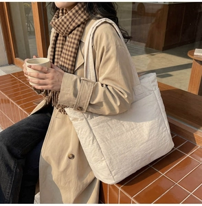 Detail of quilted large tote bag with side pocket and comfortable wide shoulder strap