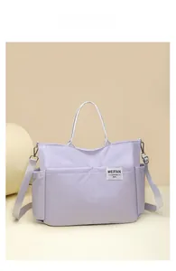 Lavender nylon tote bag featuring adjustable strap and MEIFAN logo on a studio background