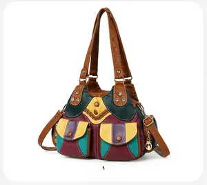 Side view detail of colorful leather patchwork handbag with pockets and brown strap