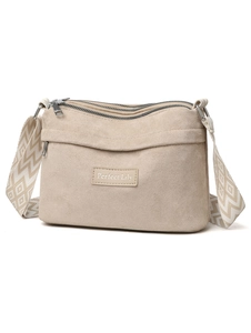 Macro view of beige suede crossbody bag with multi-zipper pockets and geometric strap