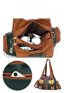 Macro detail of multicolored soft leather patchwork tote showing dual zipper compartments