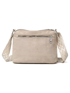 Detail of beige nylon pillow bag featuring a geometric patterned wide strap and silver zippers