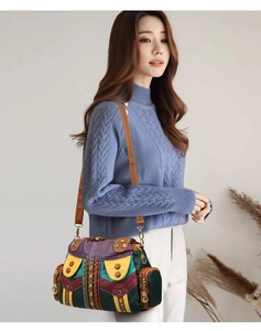 Detail of bohemian patchwork leather tote bag with rivets and decorative weaving