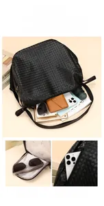 Detailed view of spacious black woven backpack interior with laptop, umbrella and wallet