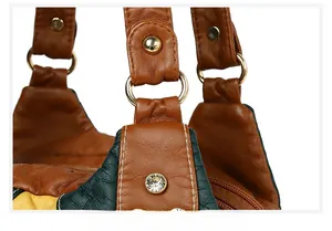 Detailed close-up of the contrasting faux leather panels and gold ring hardware on a handbag