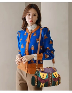 Detail of vintage patchwork leather tote featuring colorful stitching and braided accents