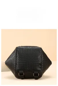 Detail of black woven texture backpack with adjustable metal buckles and nylon straps
