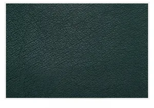 Macro detail of dark green leather texture with fine natural grain and supple finish