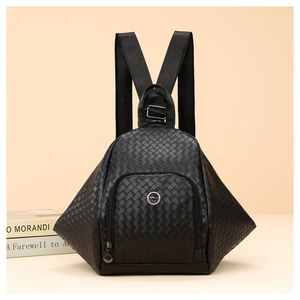 Detail of black woven texture on a triangular PU leather backpack with a metal logo