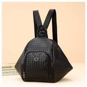 Macro detail of black woven texture and metal logo on a stylish fashion backpack