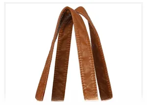 Detail of the soft caramel brown leather handle with reinforced stitching and textured finish