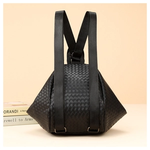 Detailed close-up of a black woven pattern backpack with adjustable textile shoulder straps