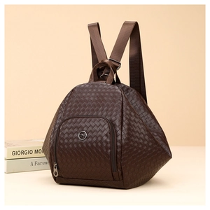 Detail of dark brown woven texture backpack with front zipper pocket and metal logo