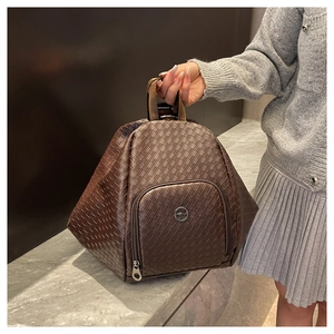 Close-up of dark brown woven PU leather backpack with kangaroo metal logo and zipper pocket