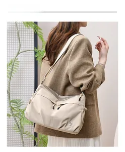 Waterproof nylon beige shoulder bag for women styled with model in a minimalist setting