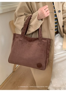 Side view of large mocha suede tote bag showing minimalist retro design and embossed logo
