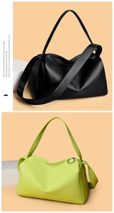 Detail view of lychee grain leather texture and metallic circular zipper on shoulder bags