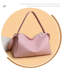 Close-up of pink pebbled leather texture on a stylish large capacity crossbody bag