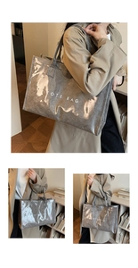 Detail of gray translucent tote bag with TOTE BAG print and comfortable leather handles