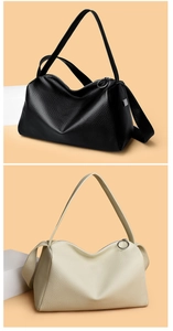 Close-up of minimalist pebble leather texture on black and off-white shoulder bags