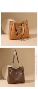 Detail view of woven leather tote bags with metal chain straps in brown and caramel