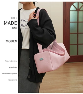 Pink lychee grain leather shoulder bag shown in a stylish daily commute outfit setting