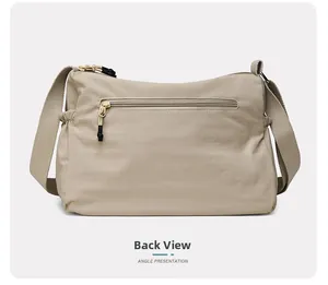 Rear view of beige water-resistant nylon shoulder bag with functional zipper pocket
