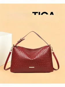Detailed close-up of a red woven leather handbag with golden metal buckle and zipper