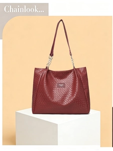 Close-up of dark red woven PU leather texture and metal chain strap on a large tote bag