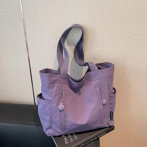 Minimalist purple nylon shoulder bag with multi-pocket design and large capacity