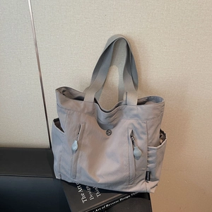 Minimalist grey nylon tote bag with large capacity and multi-pocket functional design