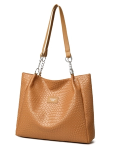 Close-up of tan woven tote bag showing leather straps and silver chain link details